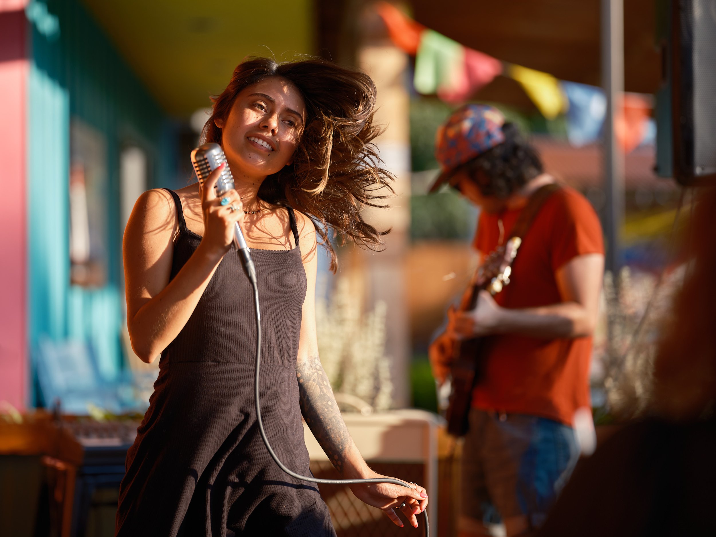 A singer is performing at Portland Mercado in Portland, Oregon.