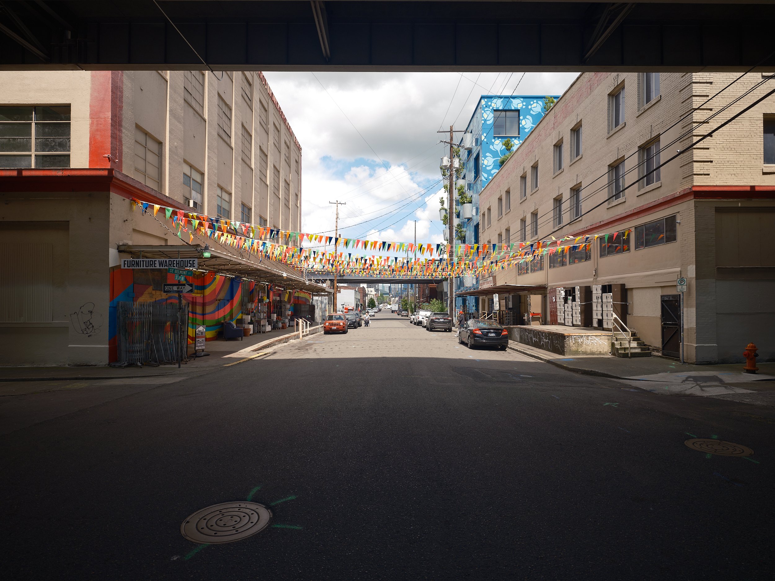 Looking down southeast third avenue with the buildings of City Liquidators Furniture Warehouse lining the street.