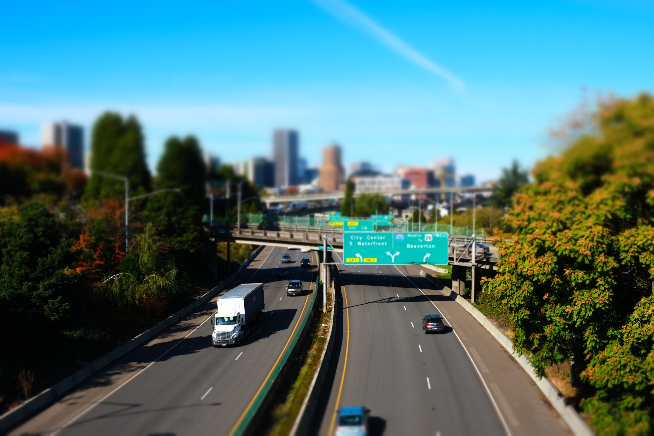 Overlooking Interstate 5 looking north towards downtown Portland. Cars and trucks are visible along both directions.